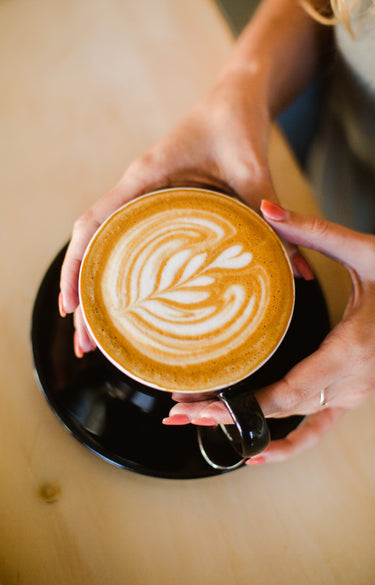 Latte with leaf latte art made using Kirenge Gold Kenyan premium coffee, showcasing rich medium roast flavor and creamy texture